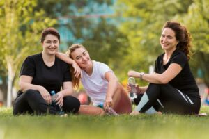 front-view-best-friends-sitting-grass-1200